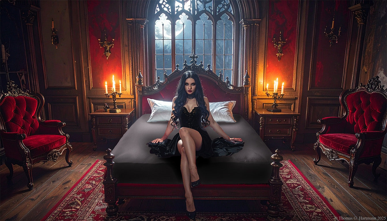 Jersey-knit stretch fitted sheet in color graghite on an extra-deep mattress — gothic woman in black dress sits in a moonlit castle bedroom