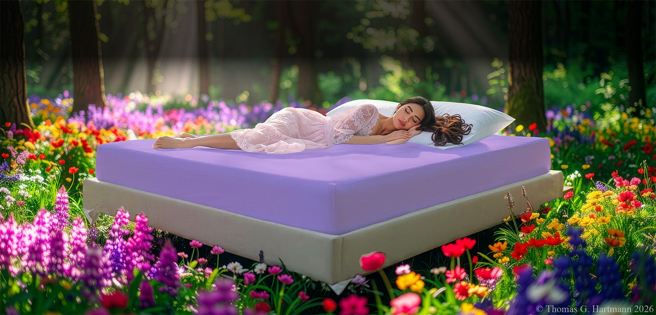 Fitted Jersey Knit stretch sheets in lilac, with a woman relaxing on the mattress in a European wellness recreational park area, surrounded by vibrant spring wildflowers.
