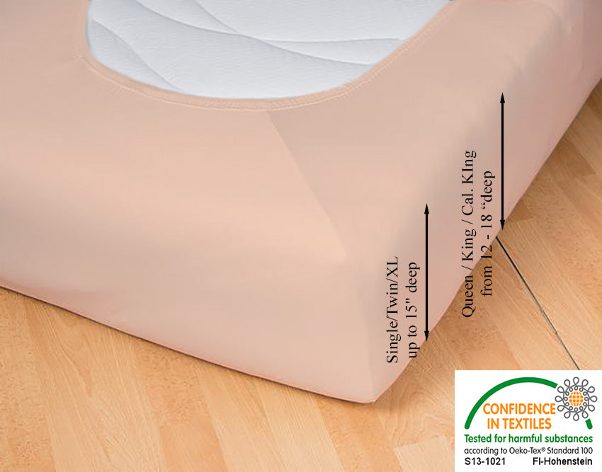 Fitted jersey knit stretch sheet in color 49-apricot, underside showing characteristic oval bottom hugging mattress, deep pocket up to 18 in, OEKO-TEX certified – Egino.