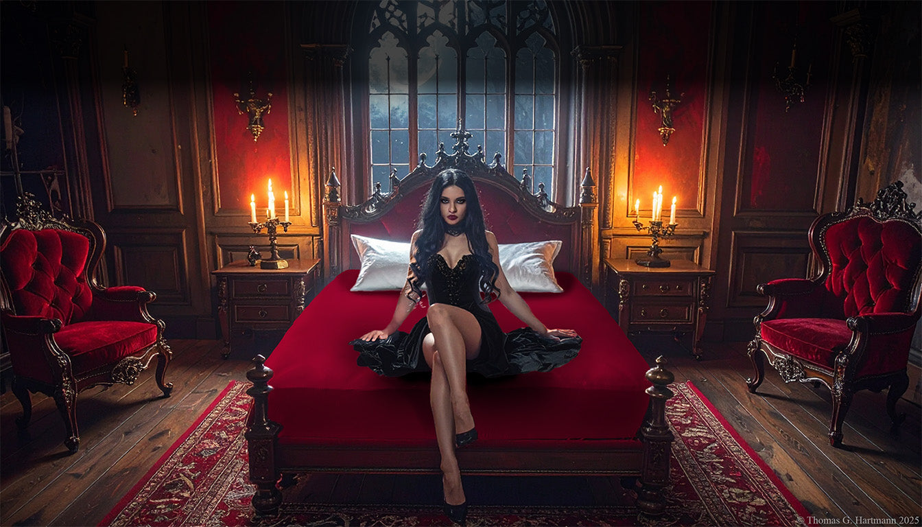 Red jersey-knit stretch fitted sheet on an extra-deep mattress — gothic woman in black dress sits in a moonlit castle bedroom.