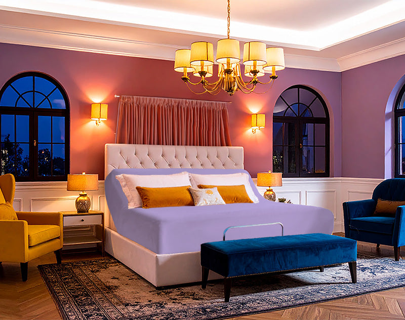 Jersey knit stretch fitted sheet on an adjustable bed, sized for up to 18-inch deep mattresses in a modern, fashion-forward bedroom.