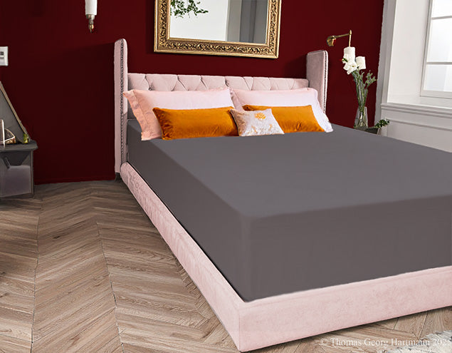 Wrinkle-free stretch jersey knit fitted sheet smoothly covering the extra deep Queen-size mattress for a luxury spa finish (graphite).