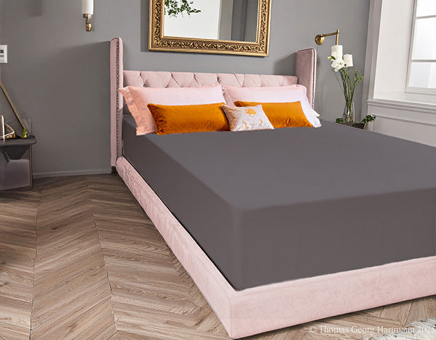 Wrinkle-free stretch jersey knit fitted sheet smoothly covering the extra deep Queen-size mattress for a luxury spa finish (graphite).